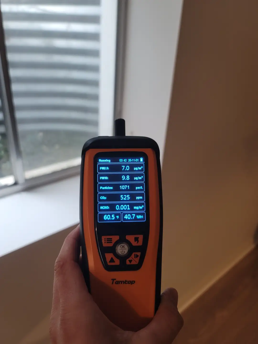 Temtop air quality monitor measuring particle levels and humidity in Miami home